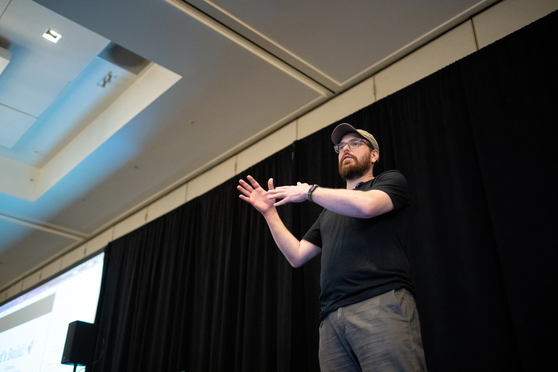 Zack explaining AI workflows and Mastra concepts on stage